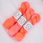 Trzy precle neonowo-pomarańczowej włóczki skarpetkowej La Bien Aimee Merino Super Sock kolor Tang